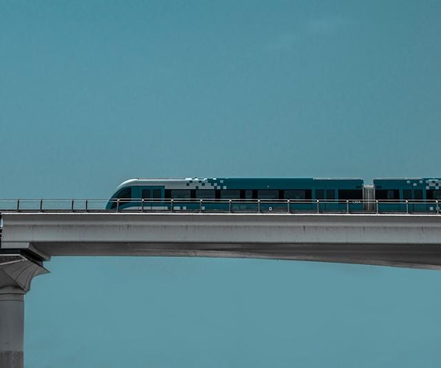 A modern train crossing a bridge, representing infrastructure investment.
